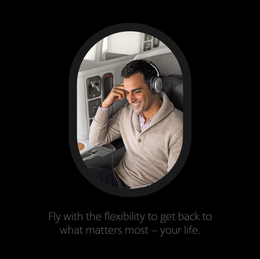 An airline passenger listening to Bose headphones while enjoying his flight.